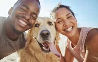 man and woman with their golden retriever
